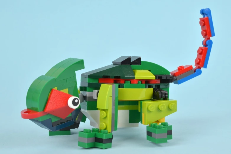 a lego green colored dinosaur with two large red and blue eyes