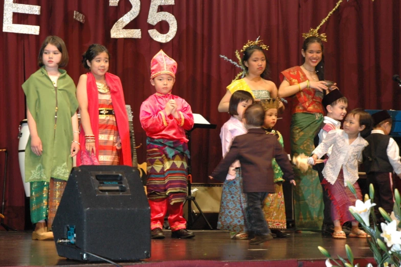 a group of children with numbers in front of them and on stage