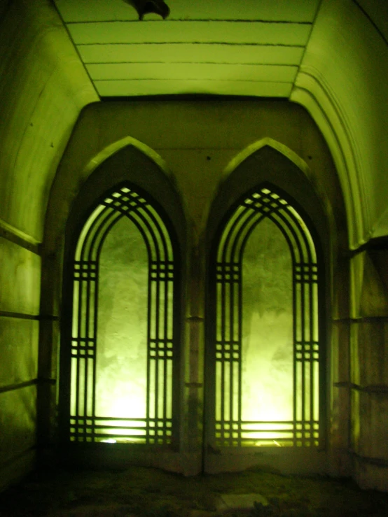 two arched windows in an old, stone building