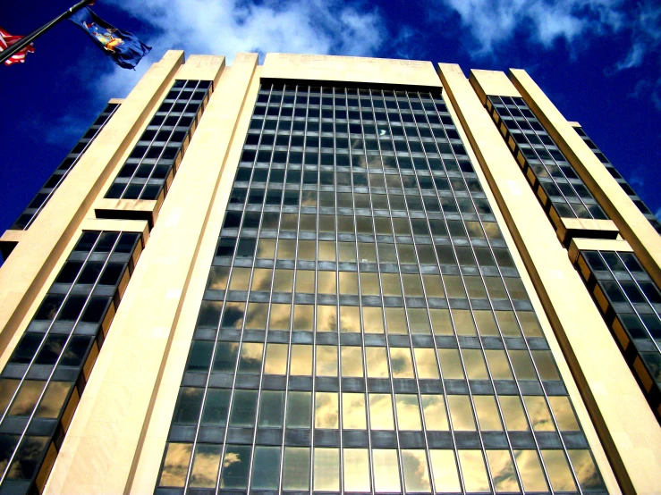 view looking up at a tall building with multiple windows