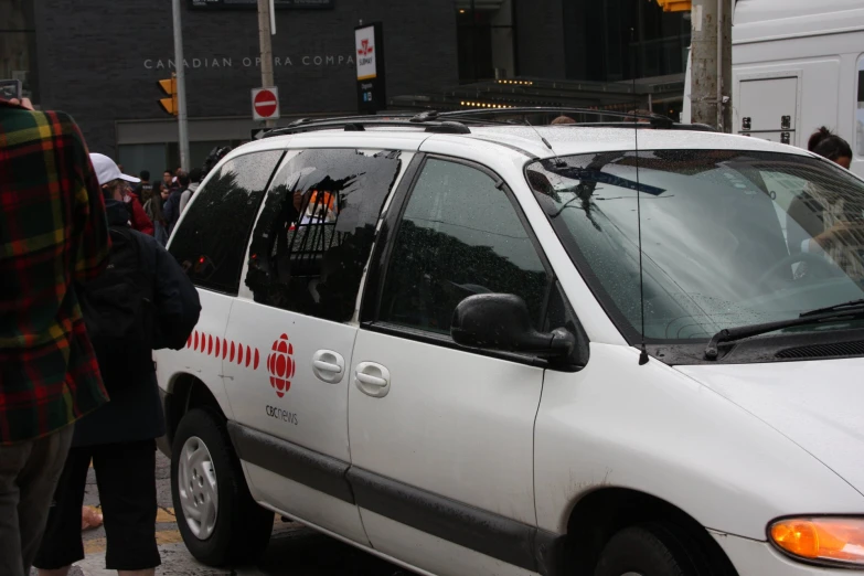 a white van is parked in the middle of the street