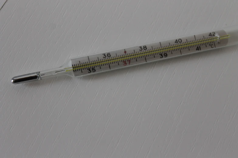 a needle resting on top of a white sheet