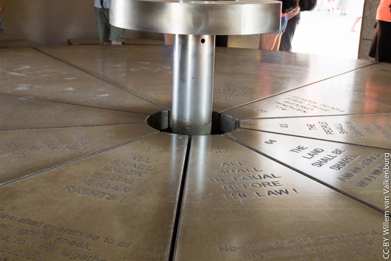 a large silver sculpture in the center of an airport