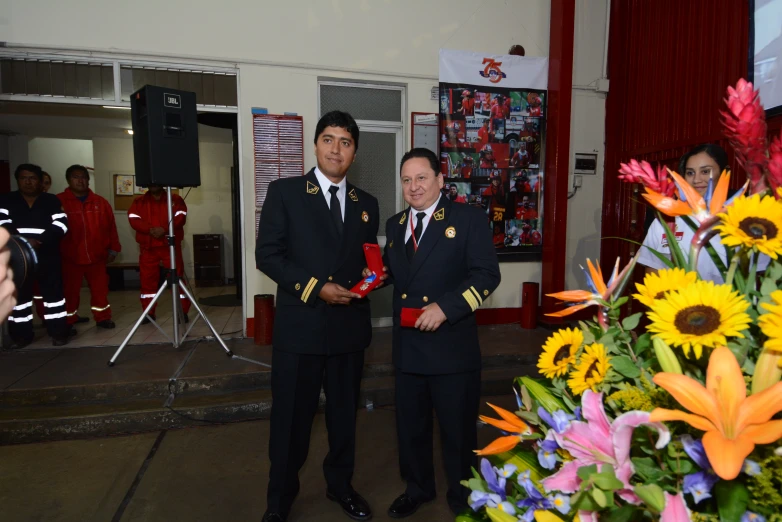 two men in military uniforms are standing outside