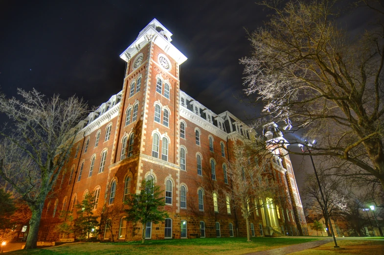 a tall building is lit up by night lights