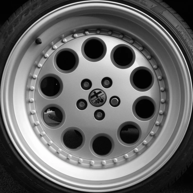 a white car tire with black spokes