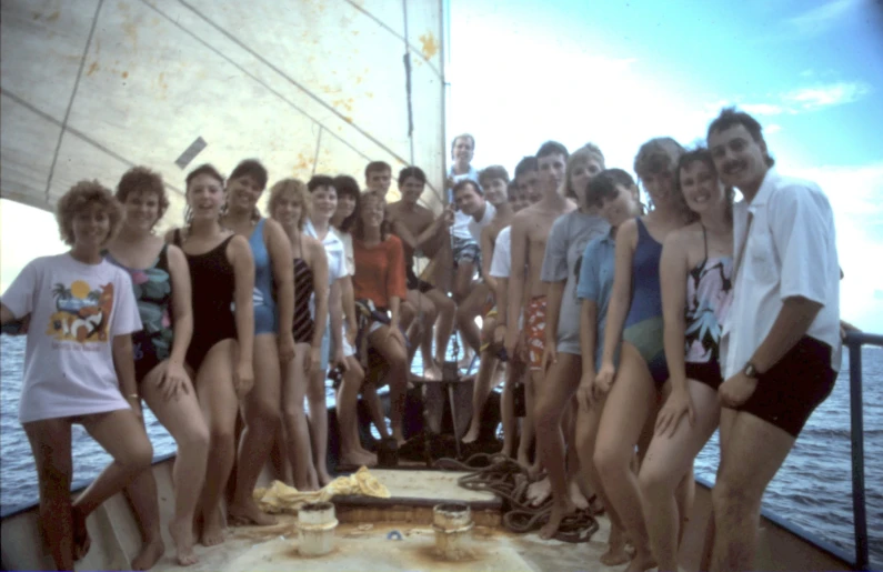 a group of people posing on a boat