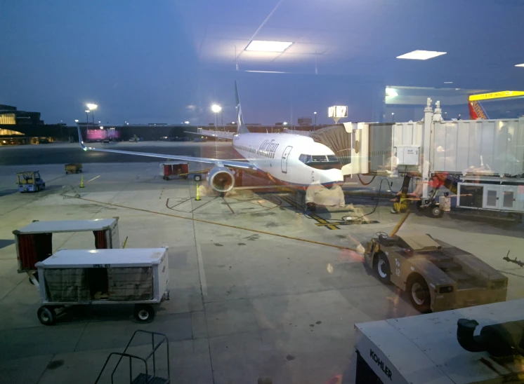 an airplane is parked in front of an airport gate