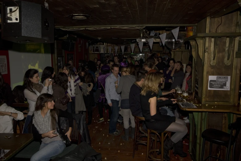 a group of people that are sitting around a bar