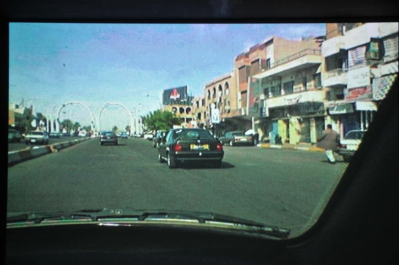 there is a car driving down this street