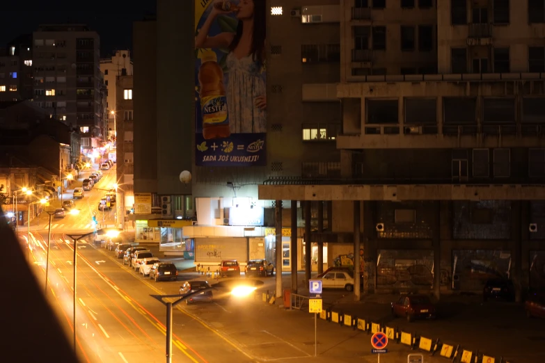 a nighttime street scene with busy traffic and tall buildings