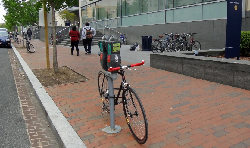 there is a bicycle  to a parking meter