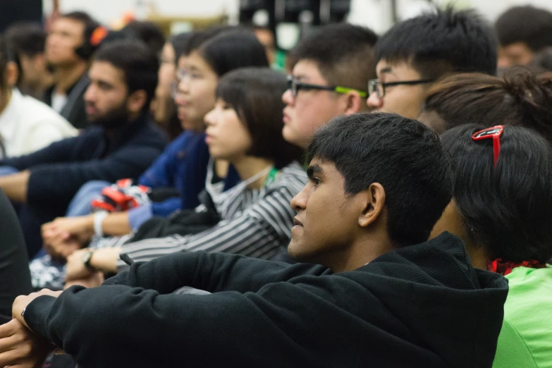 several students at a seminar all looking around