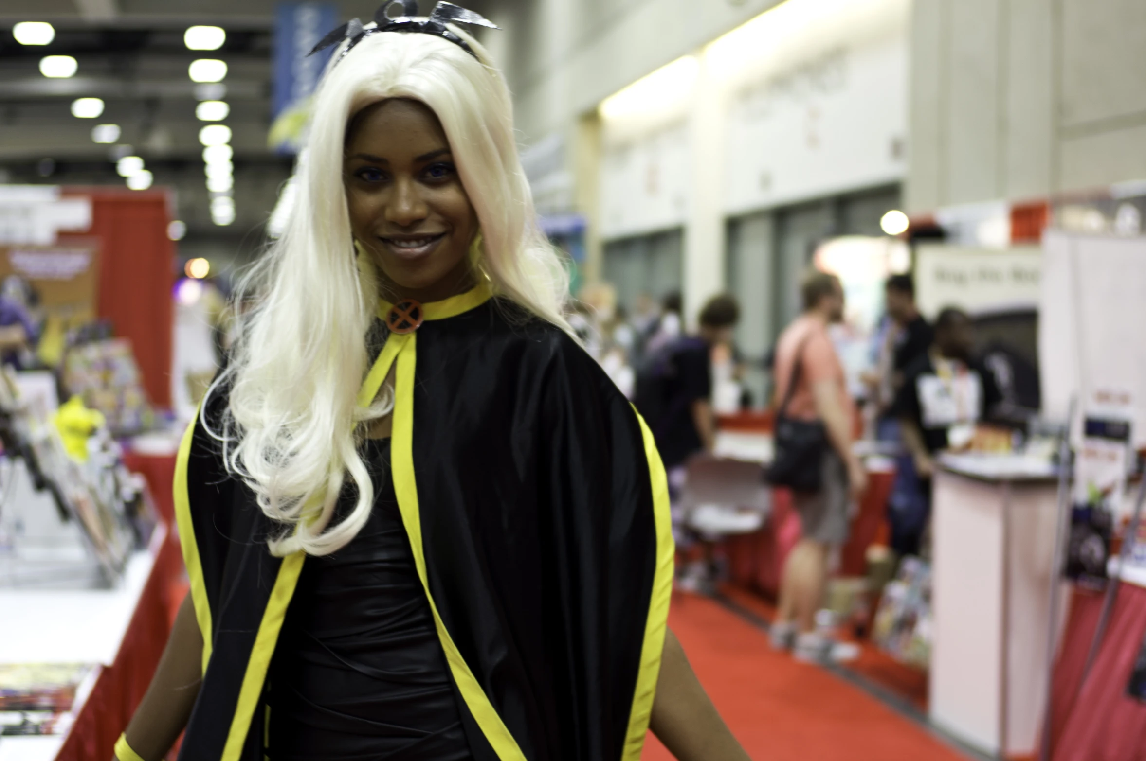 lady wearing an exotic black outfit with a yellow cape