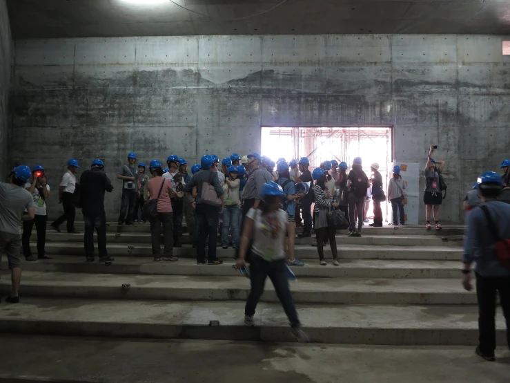 people stand in front of a wall with a lot of unfinished steps