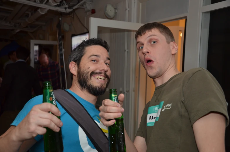 two men with beer bottles in each hand