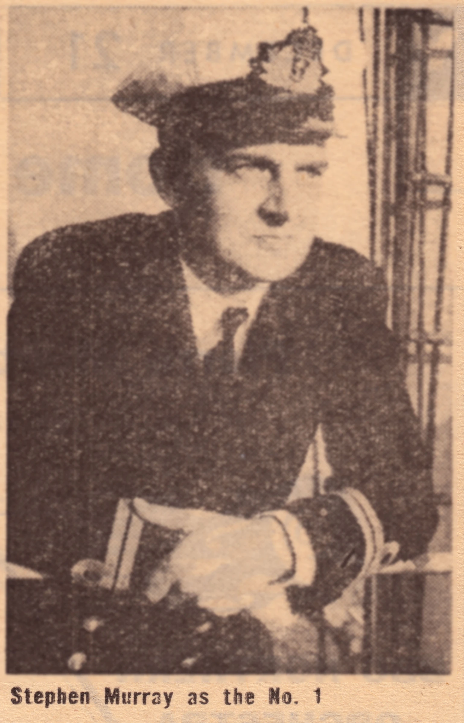 a man in a sailor uniform sitting at a table