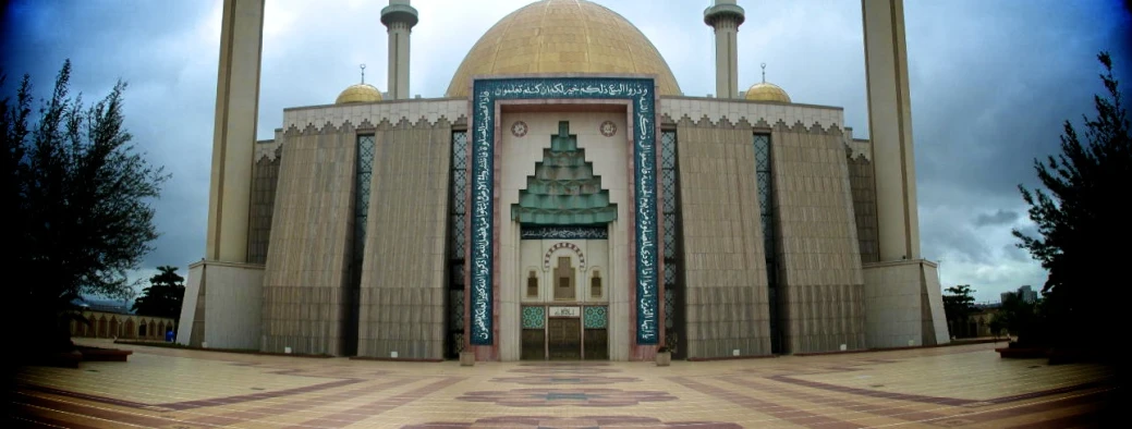 an ornately designed mosque has gold roofing