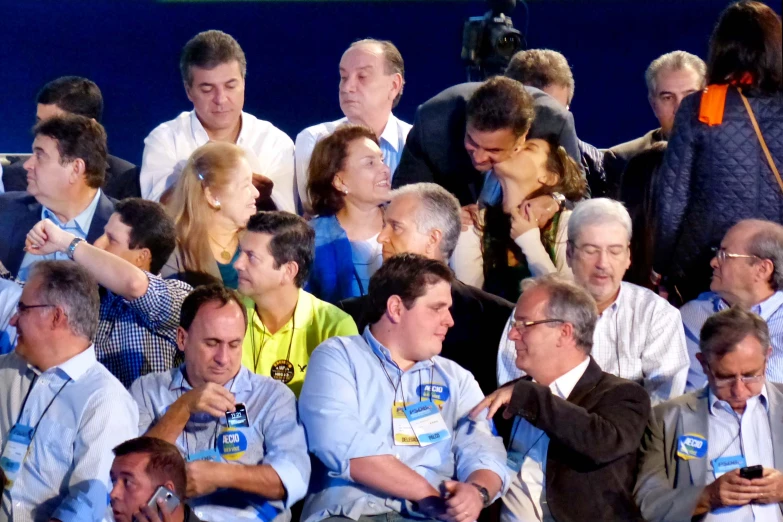 an audience of people are shown holding their cell phones