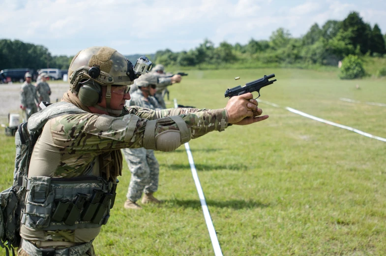 soldiers with military gear practicing their gun moves