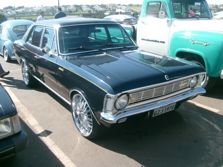 a car is parked near two older cars