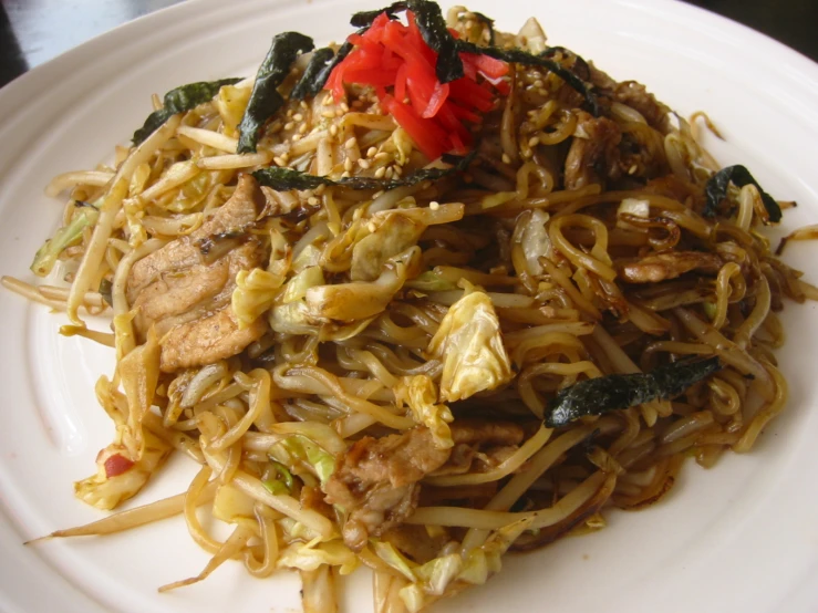 a plate full of asian food and noodles