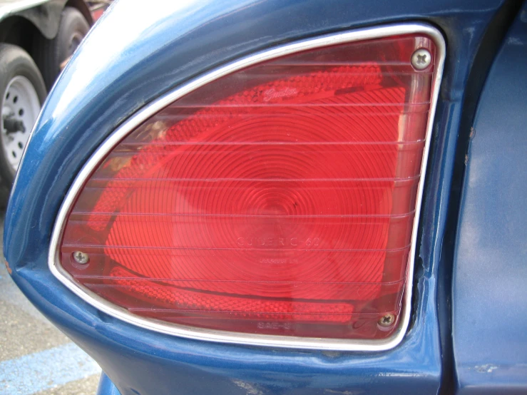 rear light of a blue hatchback car with circles on it