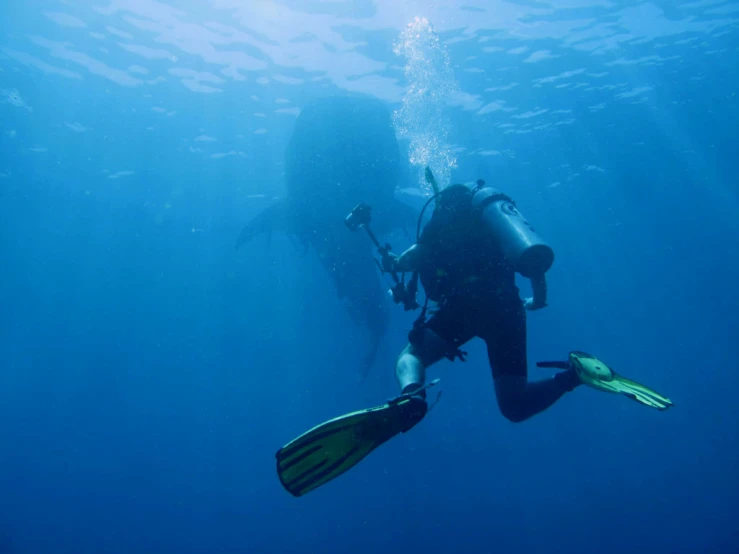 man scubas under water with open air equipment