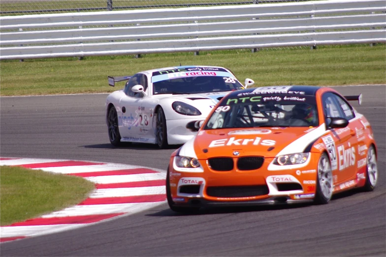 the two racing cars race down the track