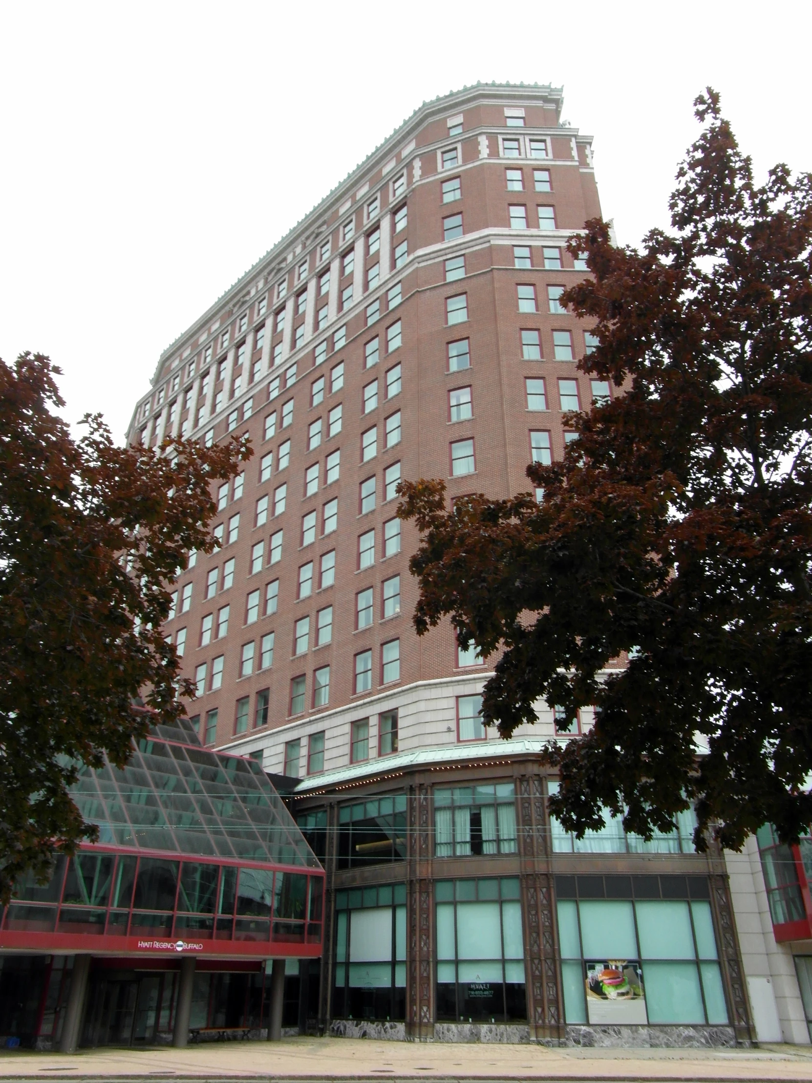 a red building with lots of windows next to trees