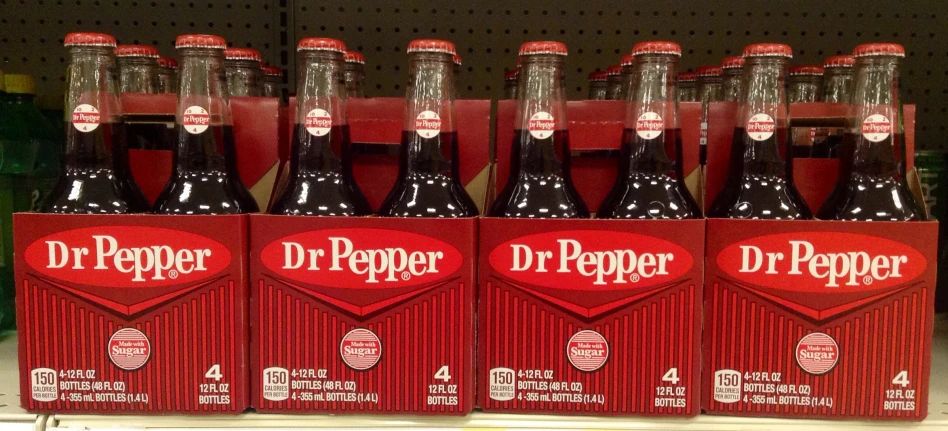 a group of dr pepper bottles sit in a store