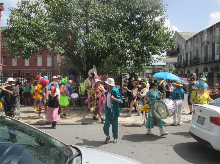 people on the street are wearing costumes and parade