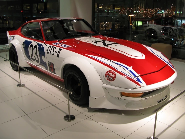 a white and red car on display in a building