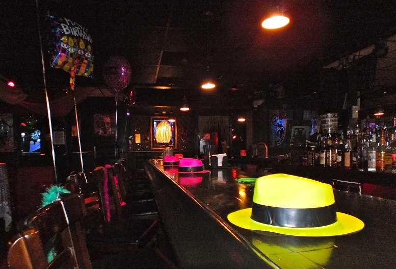 a view of a bar with some yellow and black hat on it