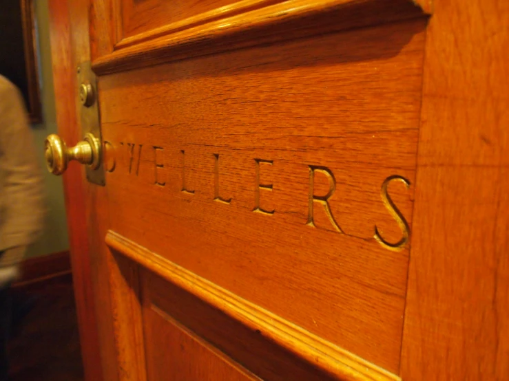 a close up of the wooden door that says sisters