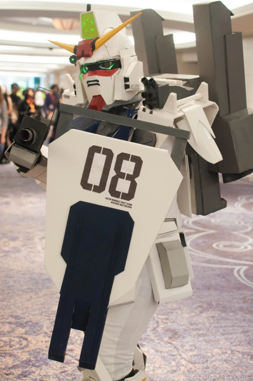 a person dressed as a robot holding a gun and wearing a helmet