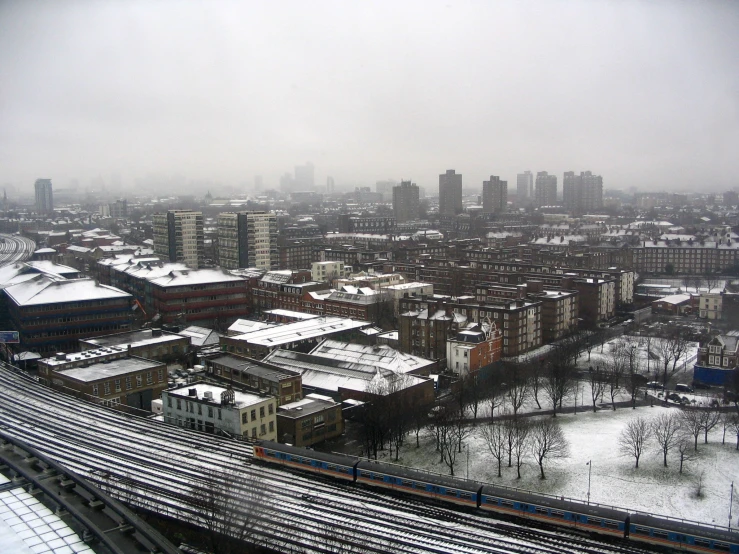 an overview of a city with tracks, buildings, and a bridge