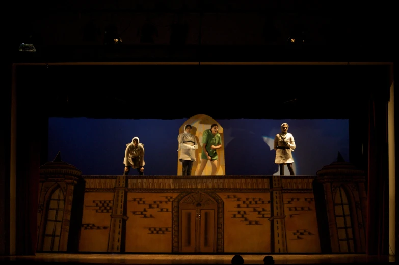 a group of statues of men standing on top of a stage