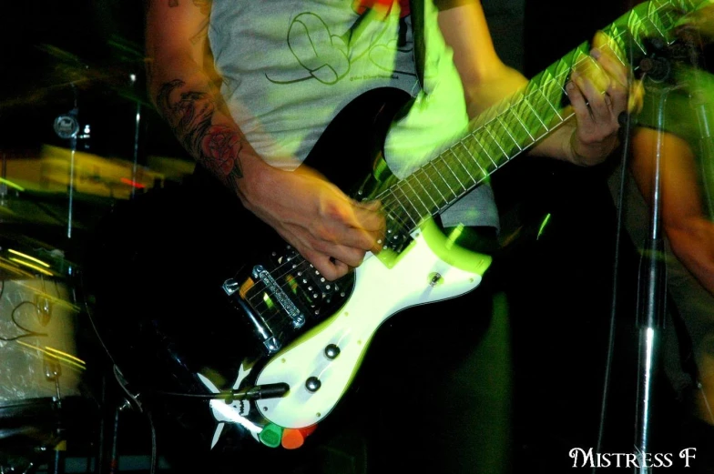 a guitarist performing with a black and white guitar