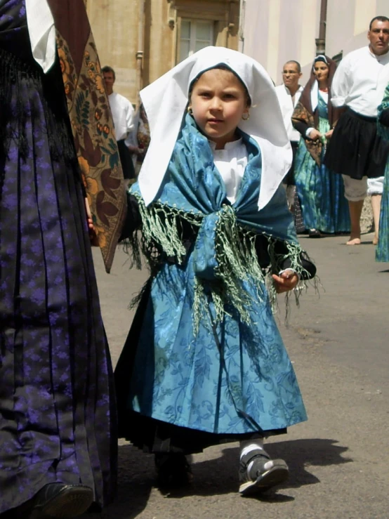 girl in blue and white dress with bonnet, walking near the other