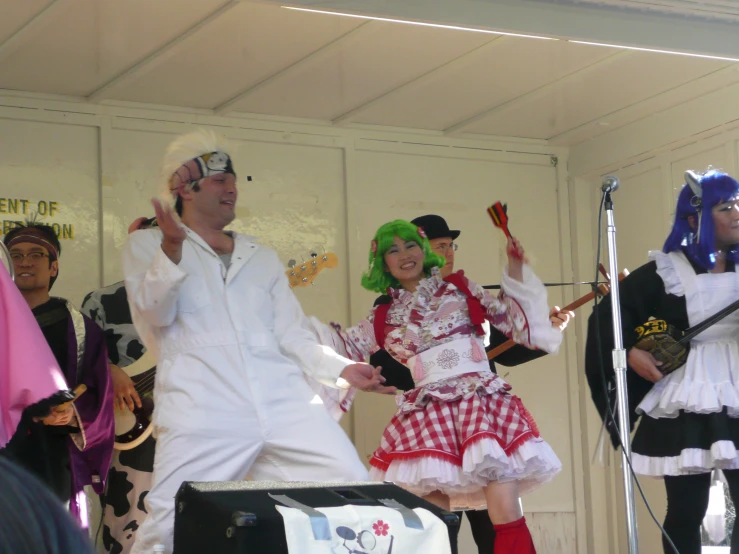 two people in costume dance and sing on stage