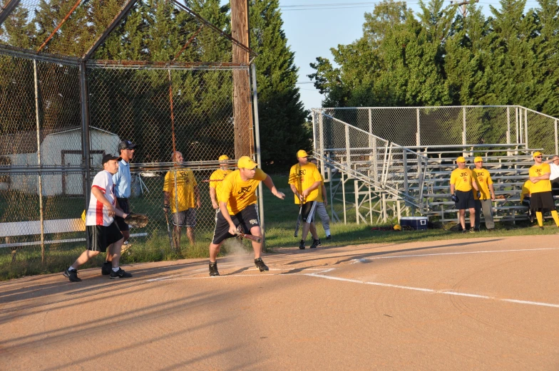 several people walking in a field with bats