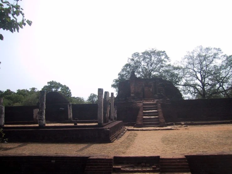 an old building surrounded by trees and bricks