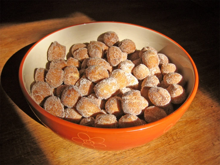 a small bowl with a lot of sugar coated treats inside