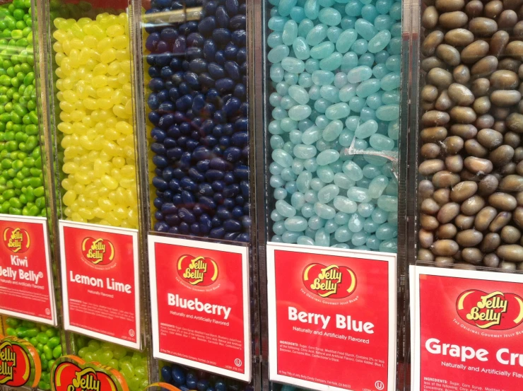 various colored chocolate candies in plastic containers for sale