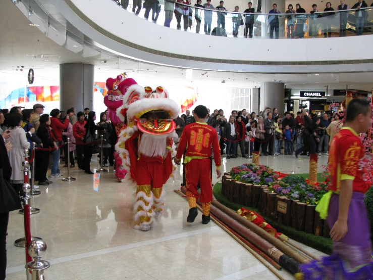 two people in elaborate costume at shopping mall