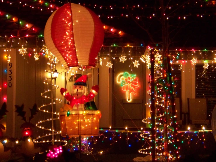christmas lights adorn a house and tree