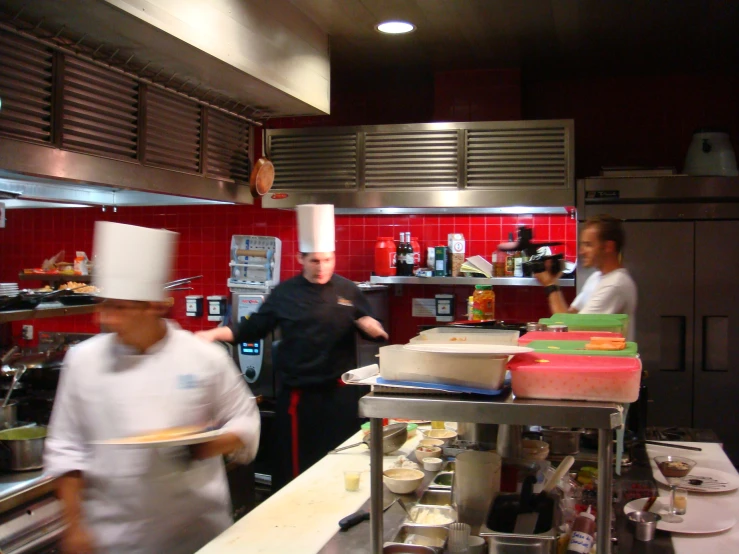 chefs are working in a large commercial kitchen
