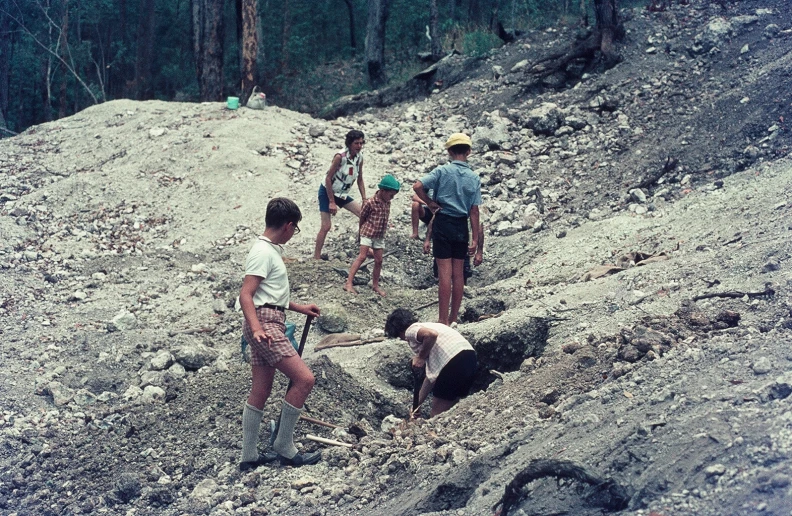 a group of people on top of a rocky hill