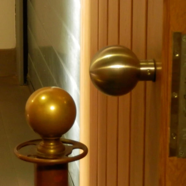 the large ball sits on top of a metal door handle